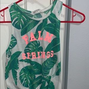a sleveless tank top with a knot on the bottom
